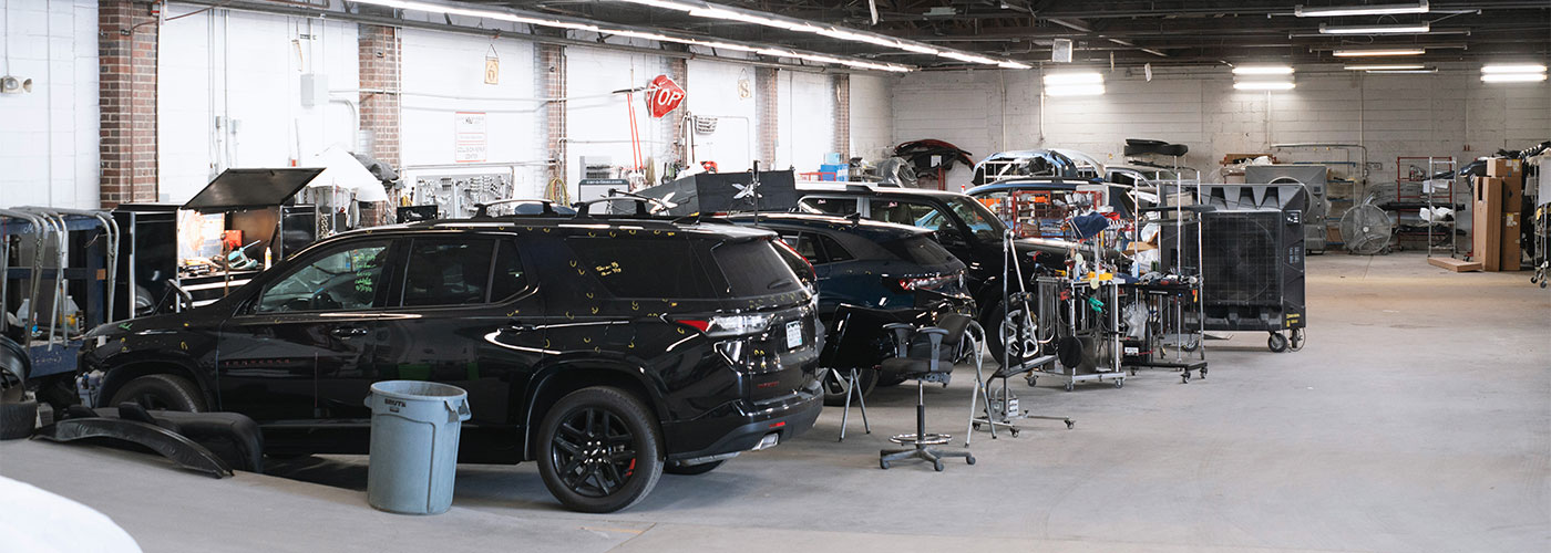 team member detailing a car